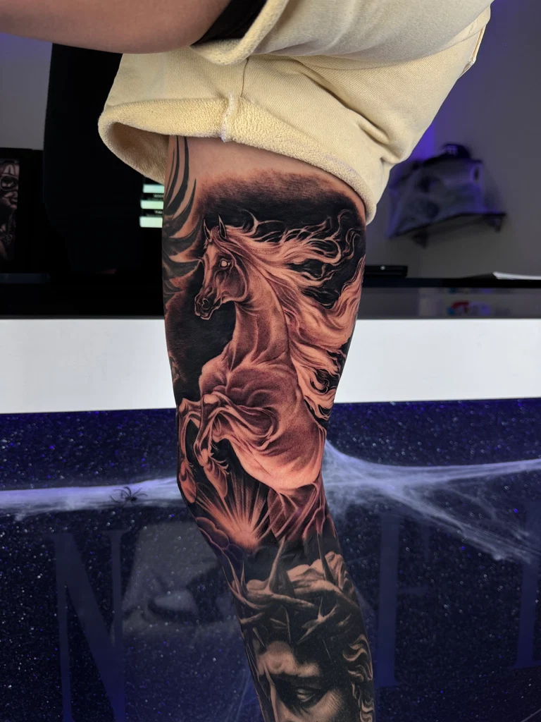 Black and grey Zeus statue forearm sleeve tattoo